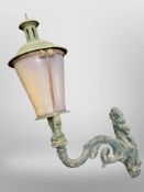 A painted metal exterior light on bracket,