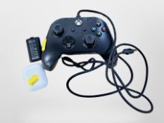 An X-box one controller, rechargeable battery and a pair of Apple wireless air pods.