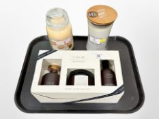 A WoodWicks warm wool candle together with Yankee Candle Vanilla cupcake and a Calm Apothecary home