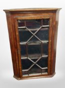 A 19th century oak hanging corner cabinet,