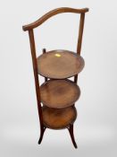 An Edwardian mahogany three tier folding cake stand and a further brass example