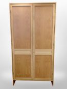 A contemporary Danish blond oak double door wardrobe,