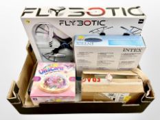A box of new retail stock items - Clear pool cover, flying drone,