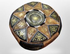 A Morrocan leather circular footstool,