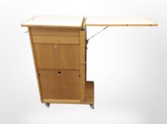 A Scandinavian oak trolley with melamine top,