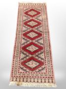 An Afghan runner of geometric design,
