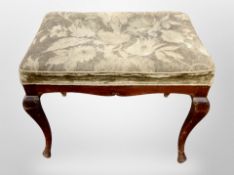 A 19th century footstool on cabriole legs