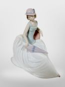 A Nao figure of a lady seated holding a parasol No. 1400.