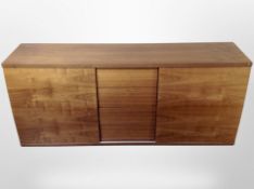 A Skovby walnut effect sliding triple door sideboard,