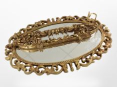 A contemporary gilt oval mirror,