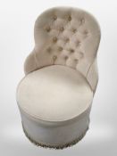 A contemporary buttoned bedroom chair