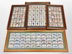 Four framed sets of cigarette cards.