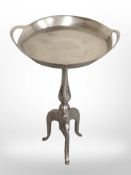 A chrome tripod table,