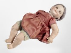 A late-19th century German porcelain headed doll, numbered 323, length, 28cm,