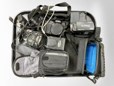 An Olympus stylus 1 digital camera, together with a Sony DSC-W110 digital still camera,