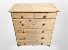 A contemporary pine six drawer chest,