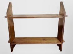 An Edwardian oak wall shelf,