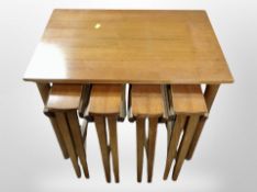 A teak nest of five tables, width 62cm.