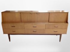 A 1970's teak inverted bow fronted cocktail sideboard,