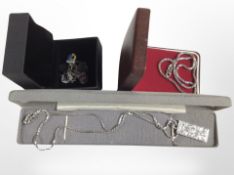 A silver ingot pendant on chain,