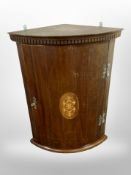 A 19th century mahogany and satinwood bow-front hanging corner cabinet,