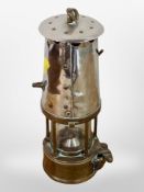 A 19th century brass and chrome miners lamp.