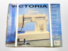 A Victoria electric sewing machine, sealed in original box.