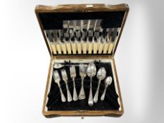 An oak canteen of stainless steel cutlery.