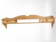 A pine wall shelf fitted two drawers, length 153cm.