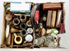 Two boxes containing continental pottery steins, carved wooden items, oil lamps, gents travel sets,