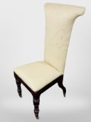 A 19th century rosewood Prie Dieu on brass castors