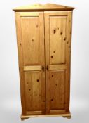 A contemporary pine double door wardrobe,