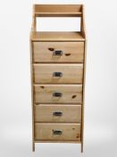 A contemporary pine five drawer chest,