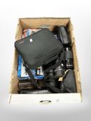 A box containing digital cameras, including Pentax, assorted camera lenses.
