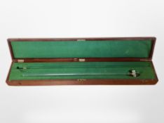 A glass burette in fitted mahogany case, with brass plaque marked 'London County Council'.