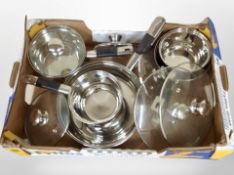 A box of contemporary kitchen cooking pots.