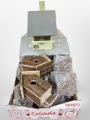 A box containing new rustic wooden bird boxes.