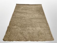 A contemporary brown shaggy pile rug, 238cm x 153cm.