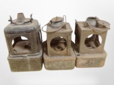 Three antique metal lanterns, a set of enameled scales with weights.