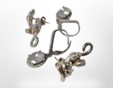 A pair of silver earrings with faceted white stones, and a further pair of silver cat earrings.