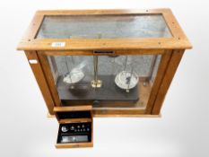 A set of Griffin and George chemist's scales in glazed box, width 50cm.