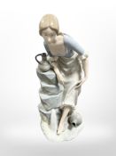 A Nao figure of a lady at a well, height 34cm.
