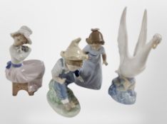 Three Nao figures of girls and a boy, and a futher swan figure.