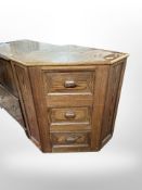 A pine three drawer corner cabinet,