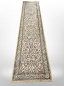 A machine made runner of Persian design,