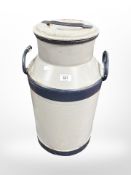 A painted metal milk churn, height 58cm.
