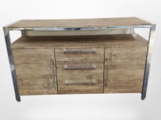 A contemporary chrome and walnut effect sideboard, length 127cm.