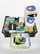 A crate containing water pump, weed controller, boxed flood light.