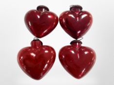 A set of 4 red glass pendant ornaments.