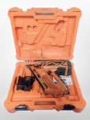 A Paslode impulse nail gun in box.